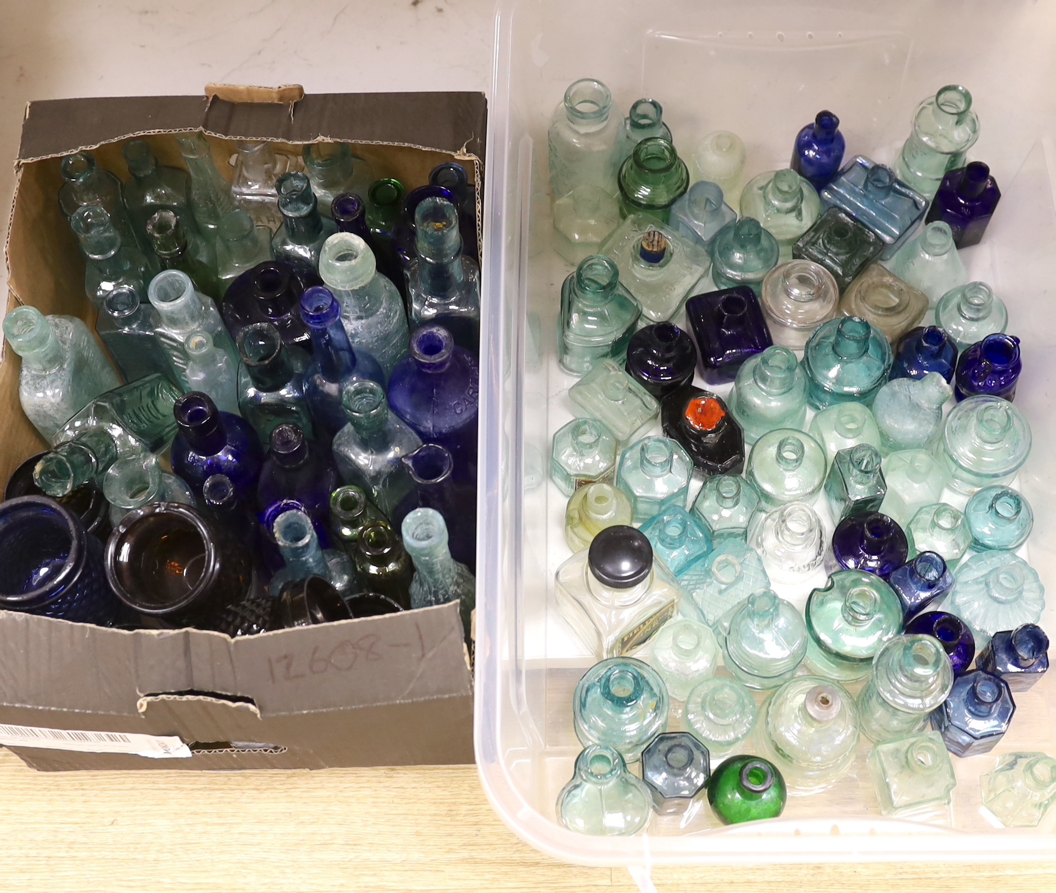A collection of late 19th/early 20th century glass ink bottles, medicine bottles, sauce bottles and other glass vessels, brand names and advertising moulded into the glass on some examples, original paper labels to two i
